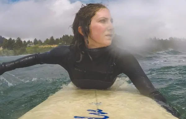 Maia Insinga paddles her surfboard