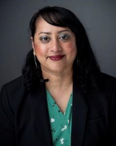 Headshot of a woman wearing black suit